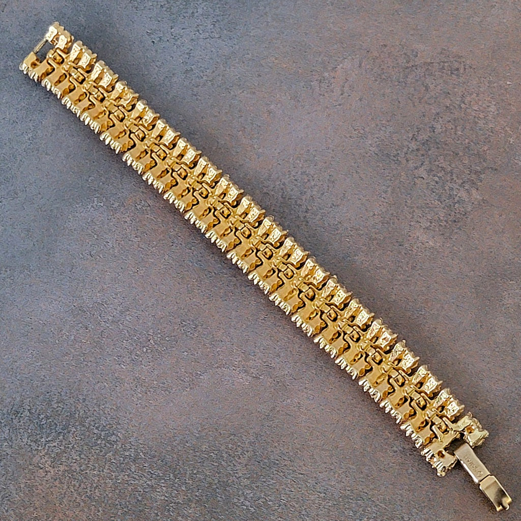 Back side of a vintage gold tone link bracelet by Sarah Coventry.