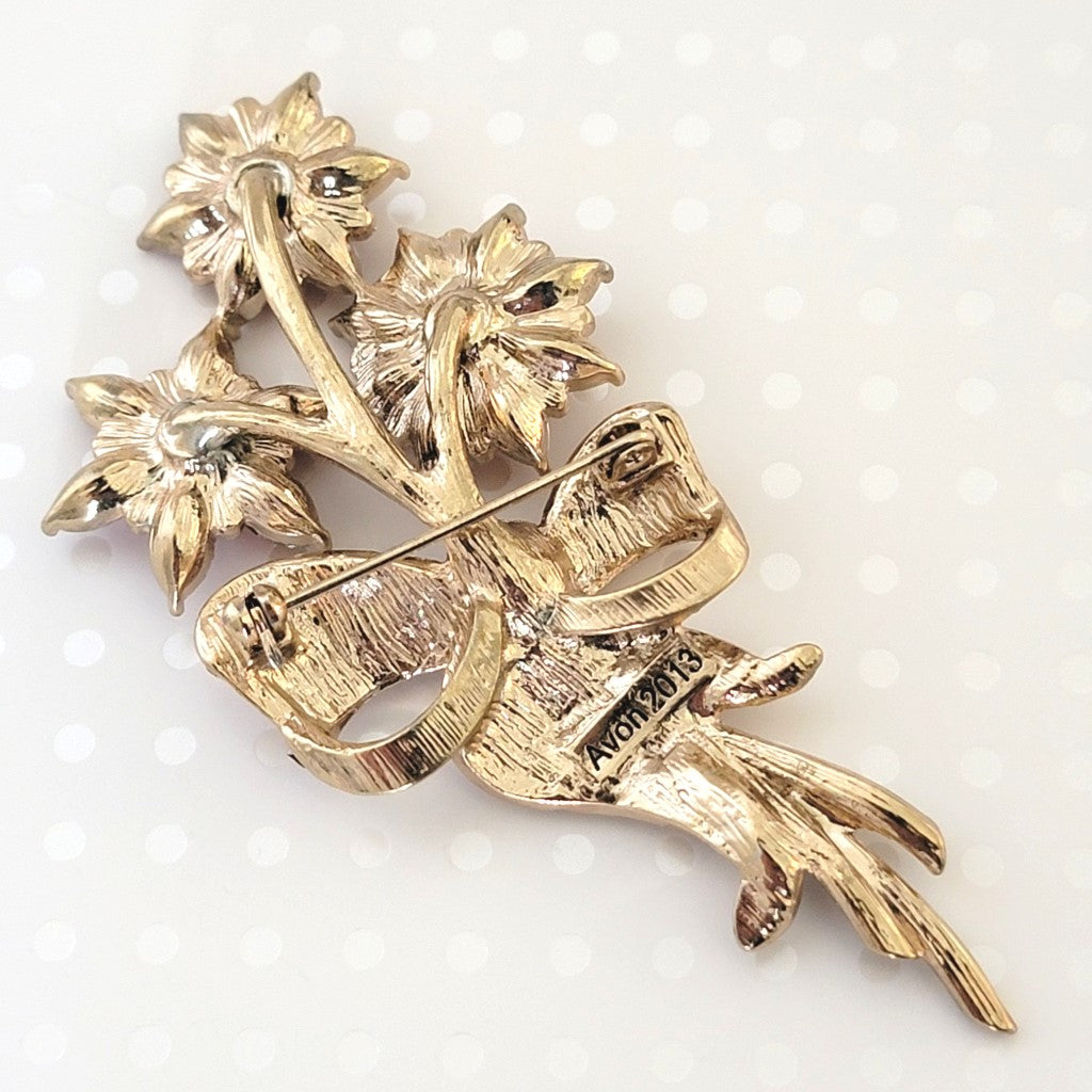 Back view of an Avon Christmas brooch, showing signature.