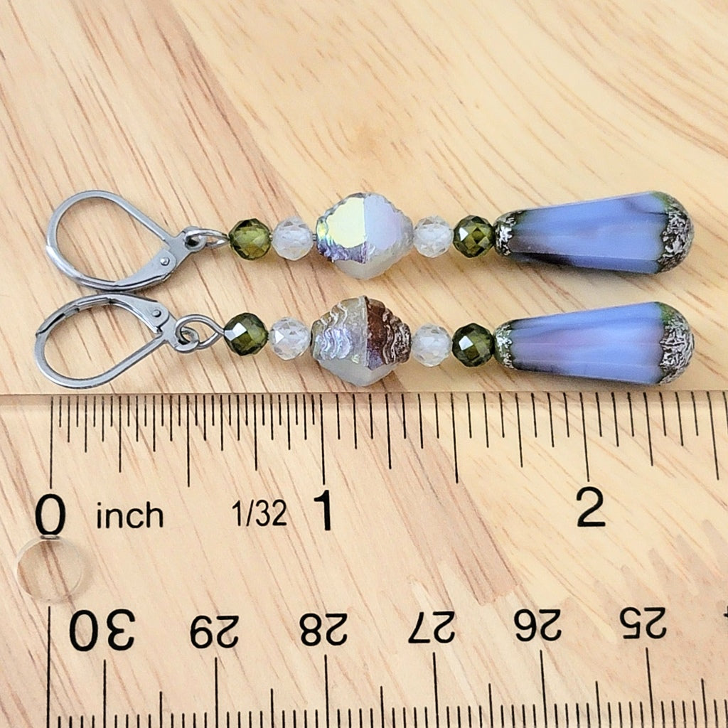 Blue teardrop earrings with ruler.