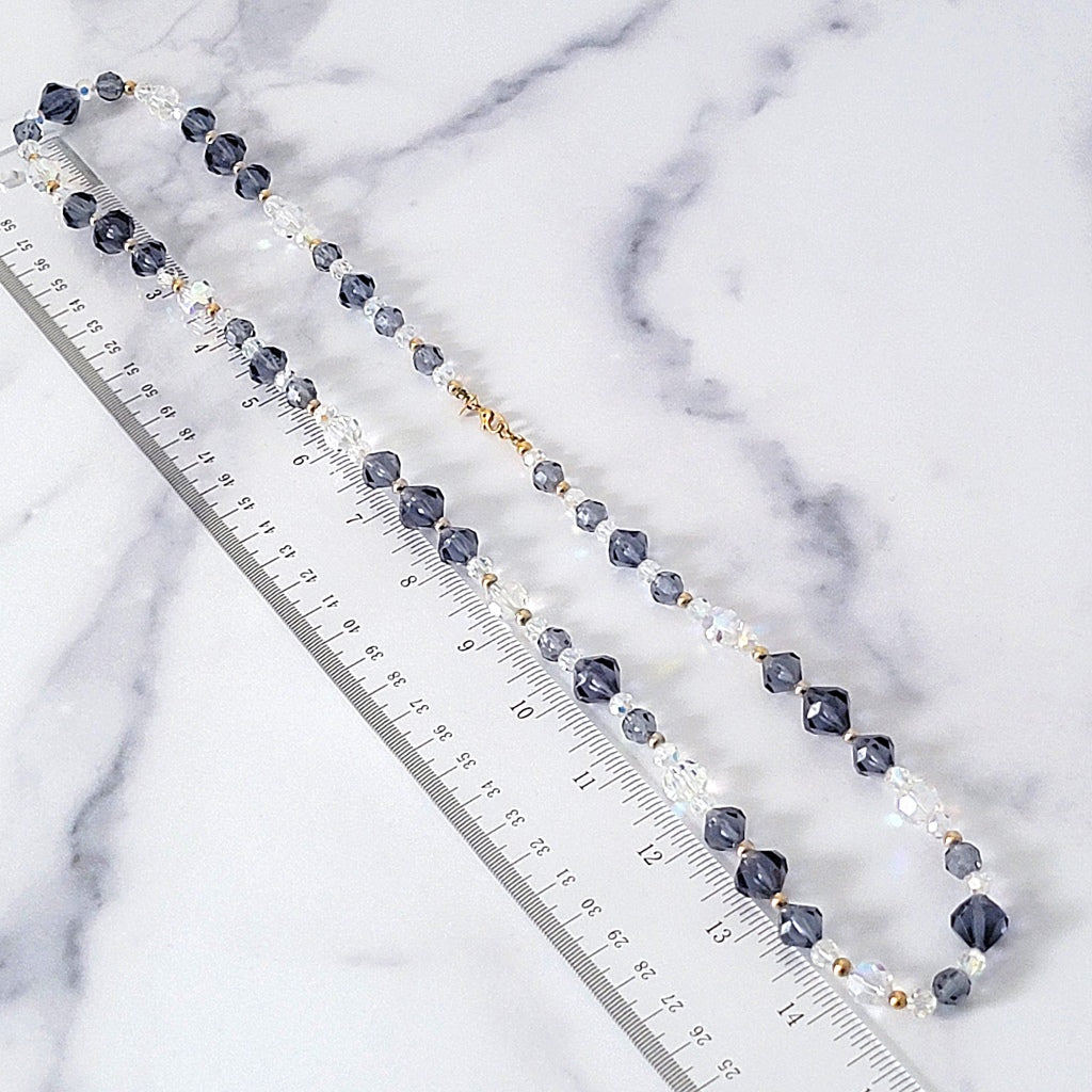 Long beaded necklace next to a ruler.