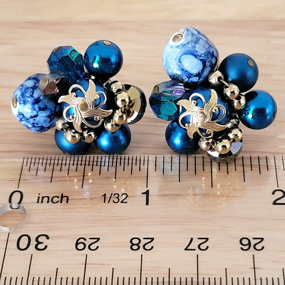 Blue bead cluster earrings next to a ruler.