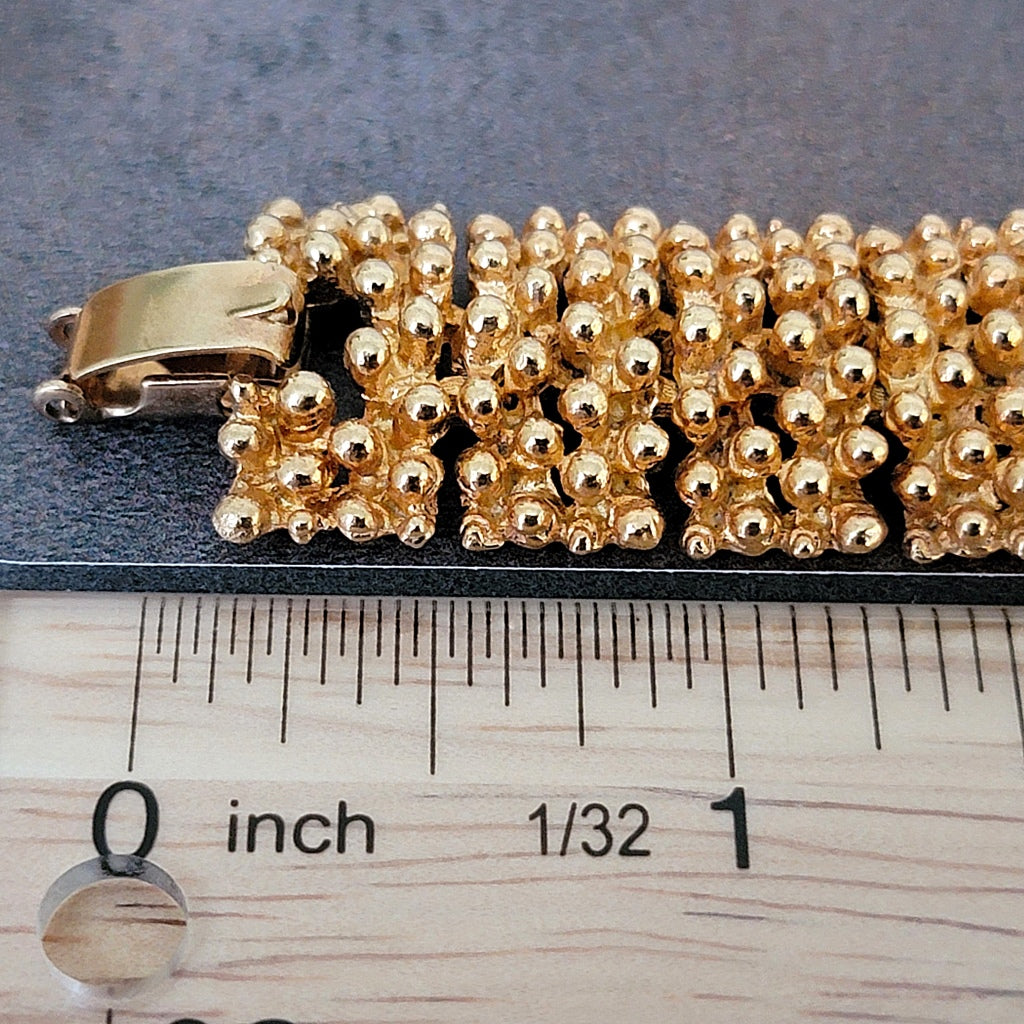 Bracelet clasp next to a ruler.