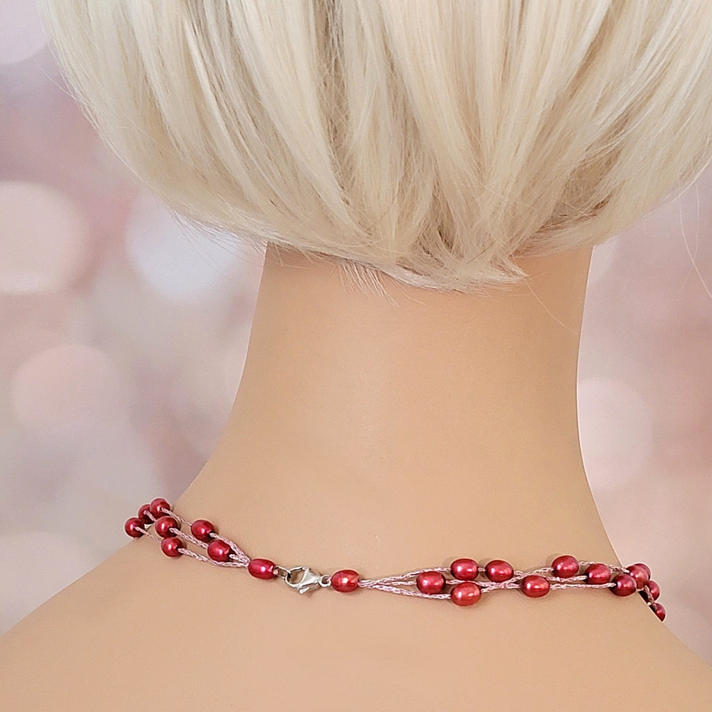 Back of red pearl necklace on mannequin.