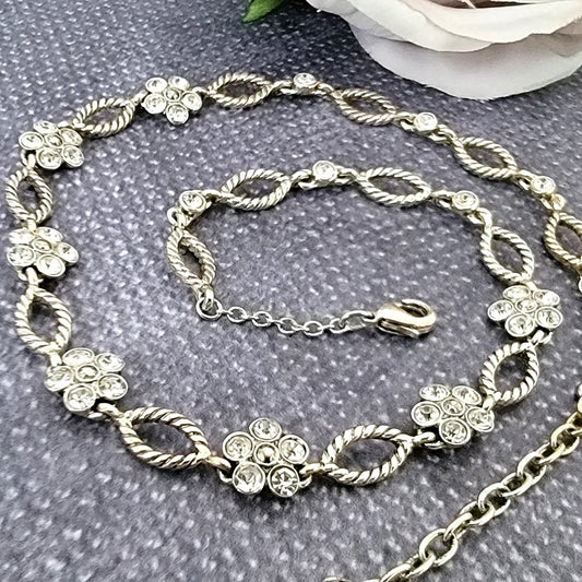 Silver tone flower rhinestone choker necklace.