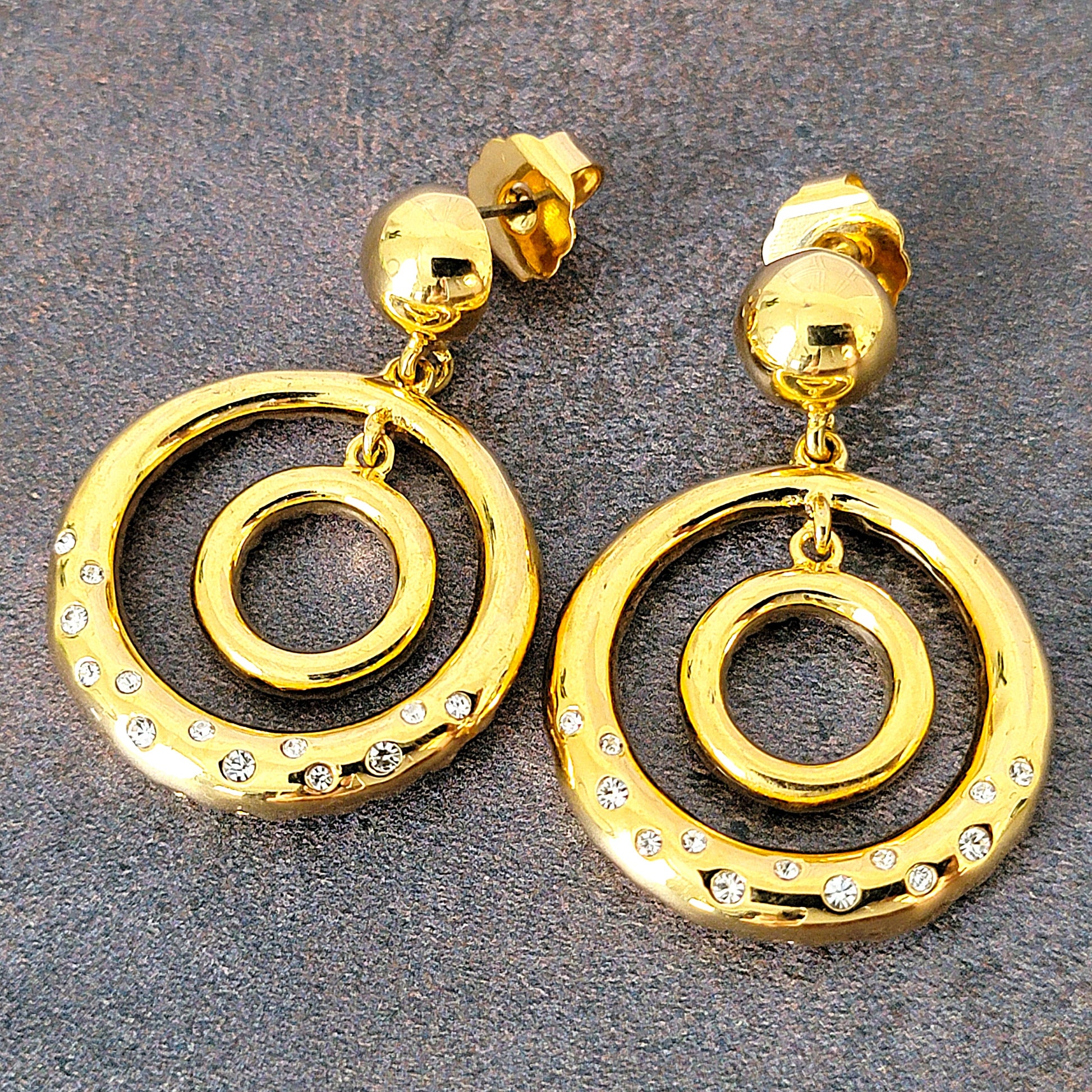 Gold tone double circle dangle earrings with rhinestones.