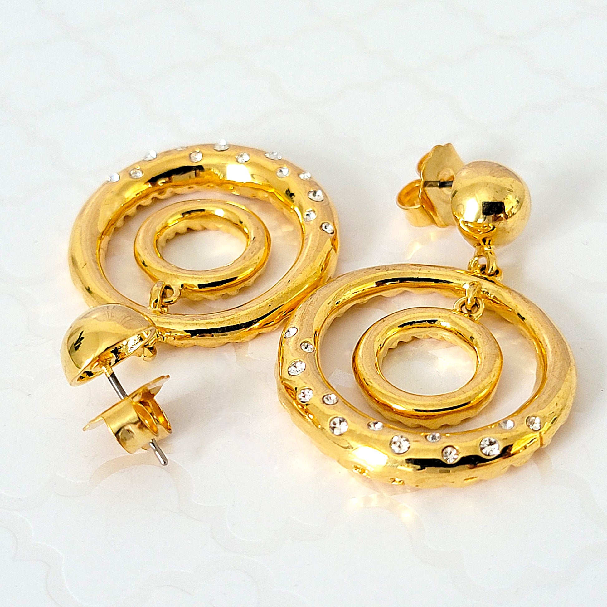 Rhinestone double gold tone hoop earrings.