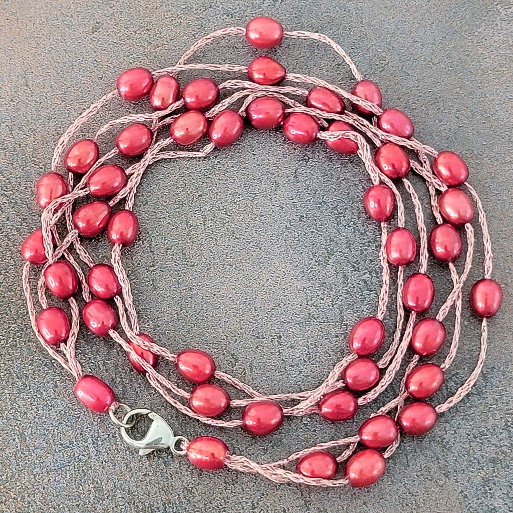 Red floating pearl necklace.