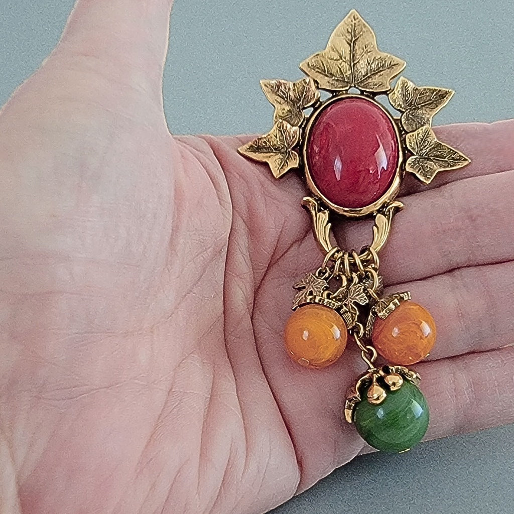 Leaf dangle brooch in hand.