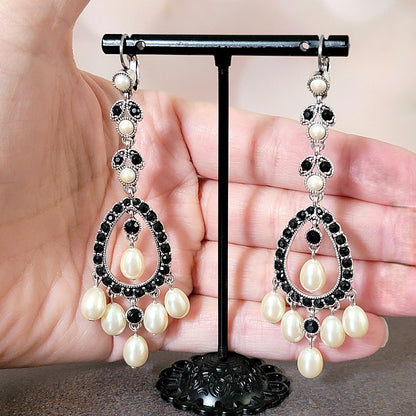 Long dangle earrings in hand.