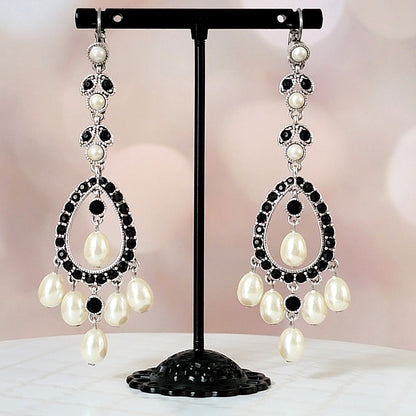 Black and faux pearl dangle earrings.