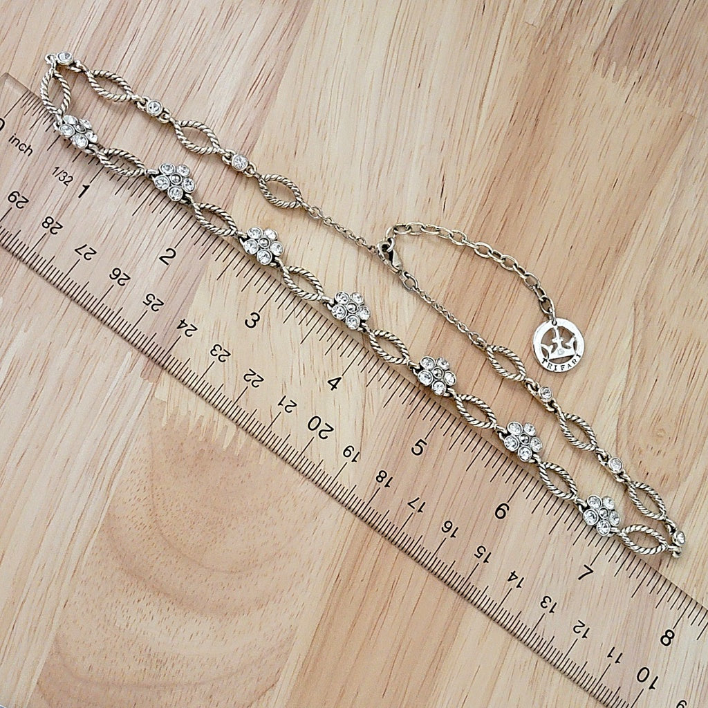 Trifari silver tone necklace next to a ruler.