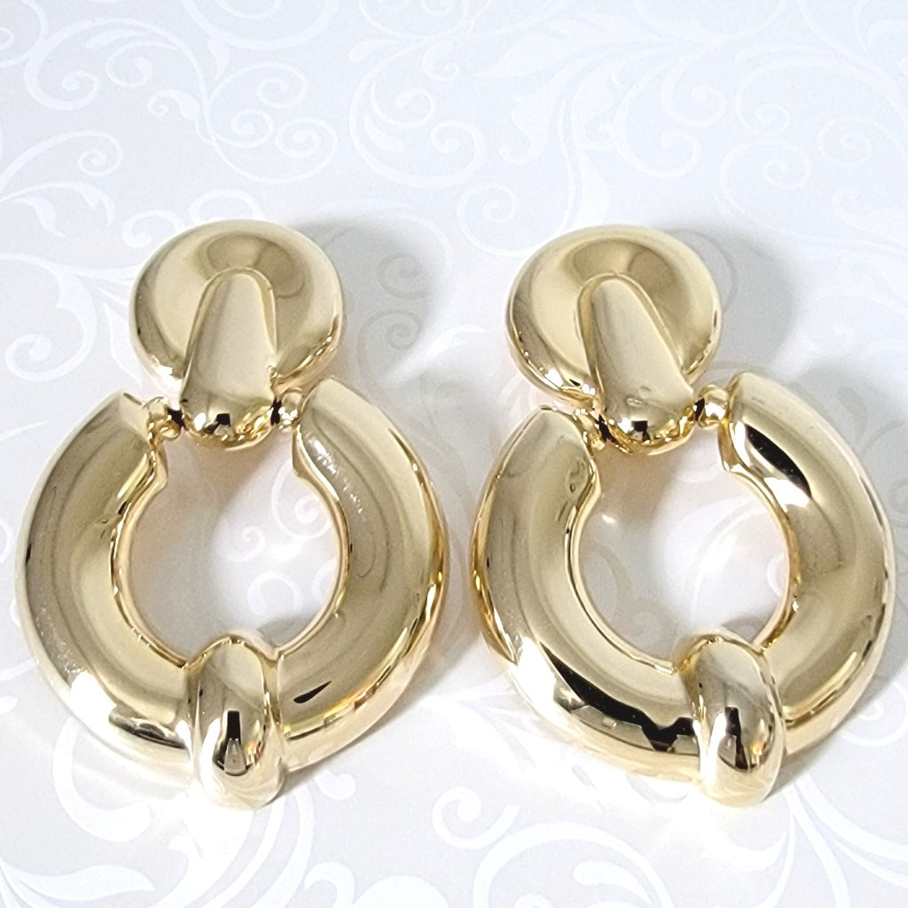 Big gold tone hoop, door knocker clip on earrings.