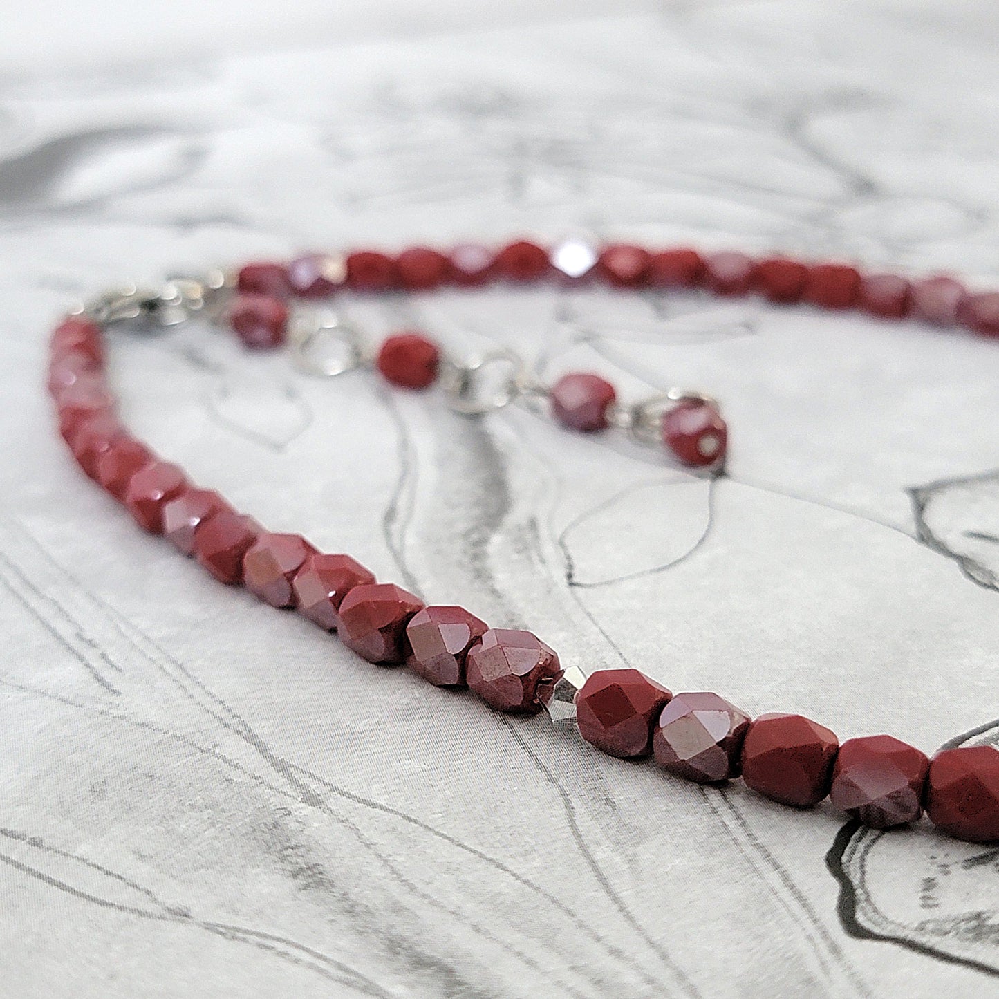 Dark red faceted glass beads.