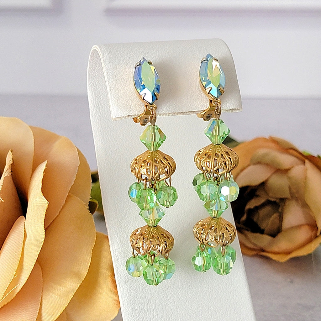 Long light green glass chandelier earrings.