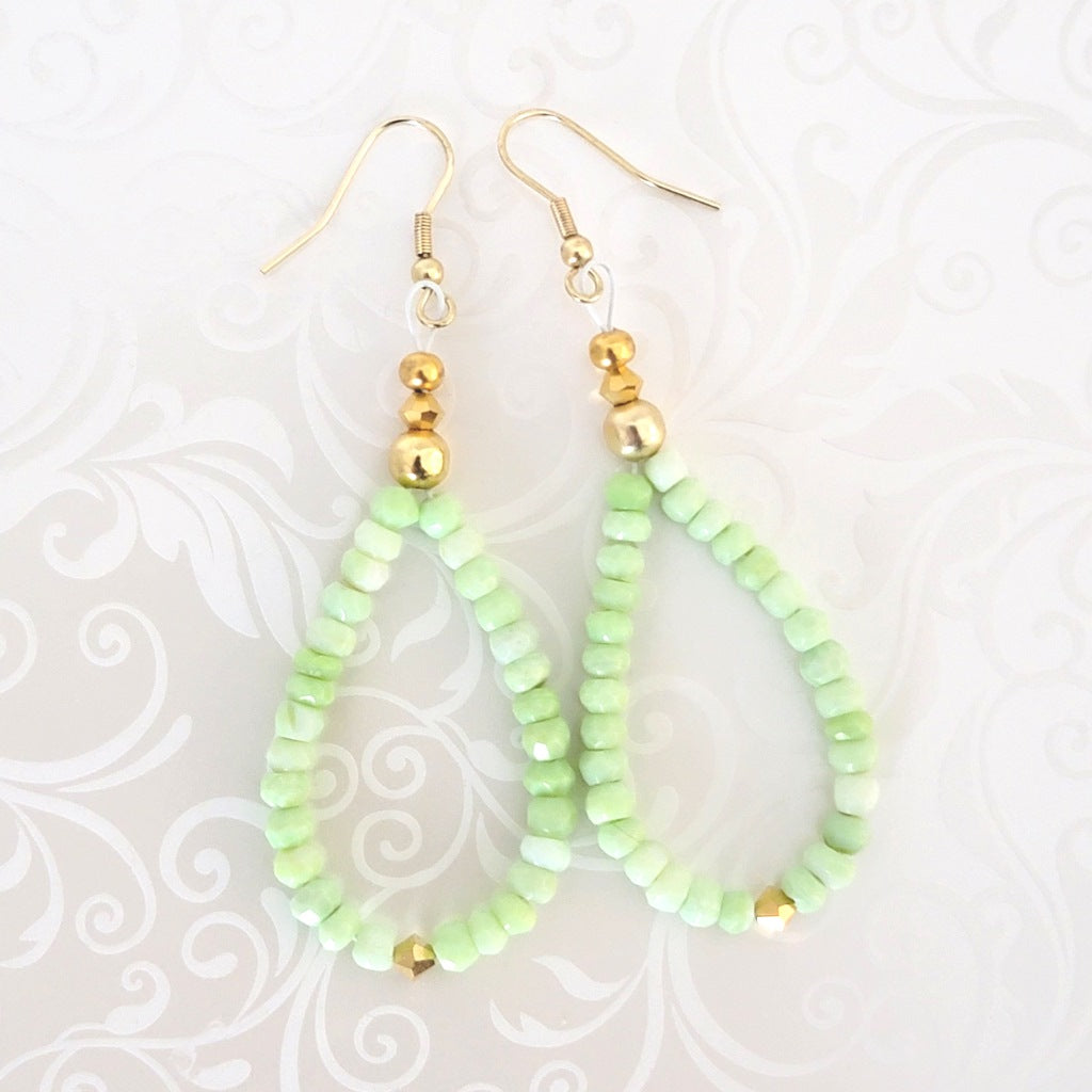 Handmade green opal beaded dangle earrings, with gold crystal accents.