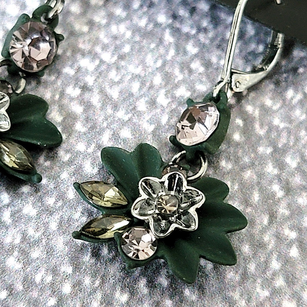 Detail green enamel and rhinestone flower earring.