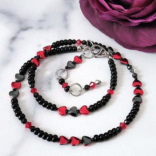 Black choker necklace with red hearts.