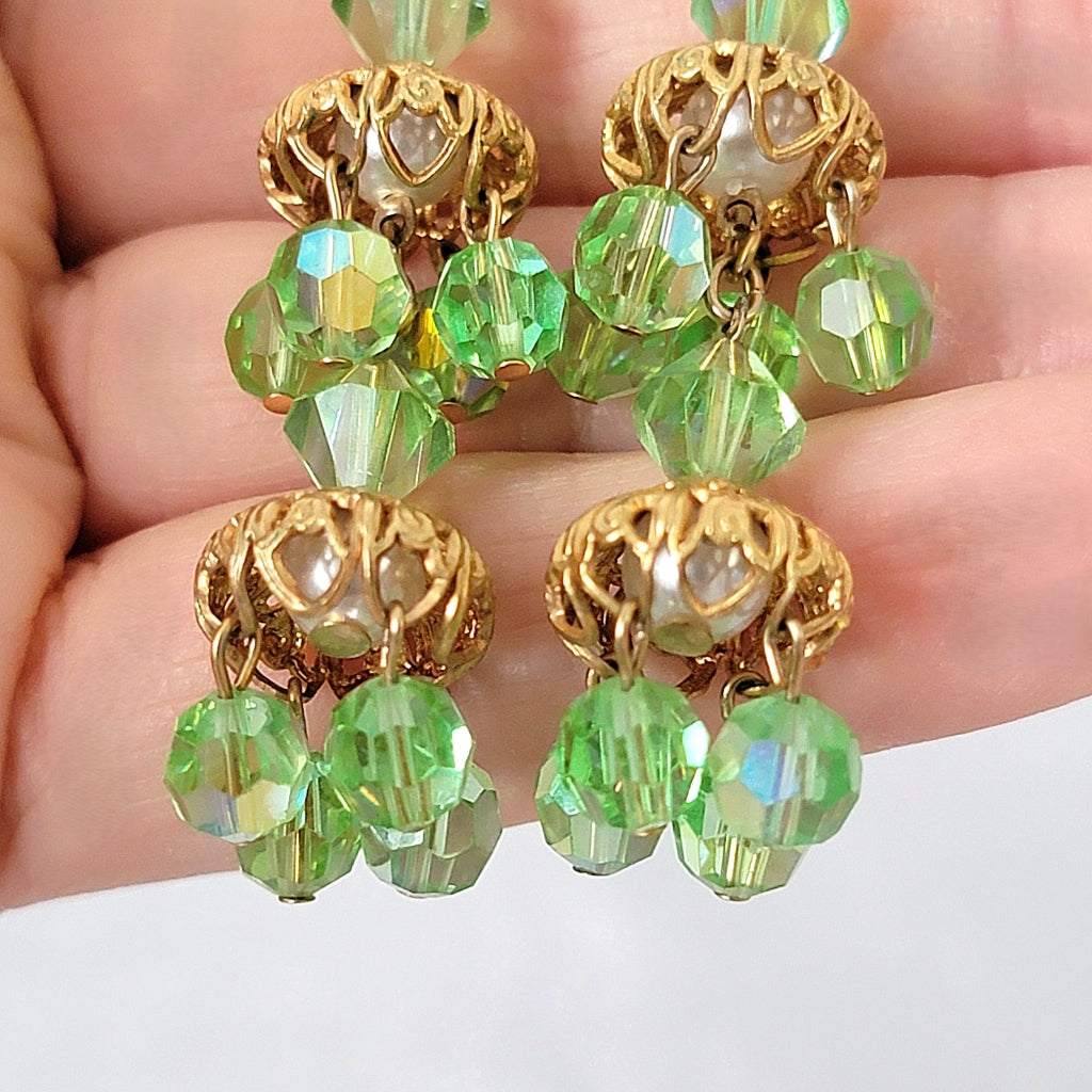 Detail of gold filigree and green beads on vintage earrings.