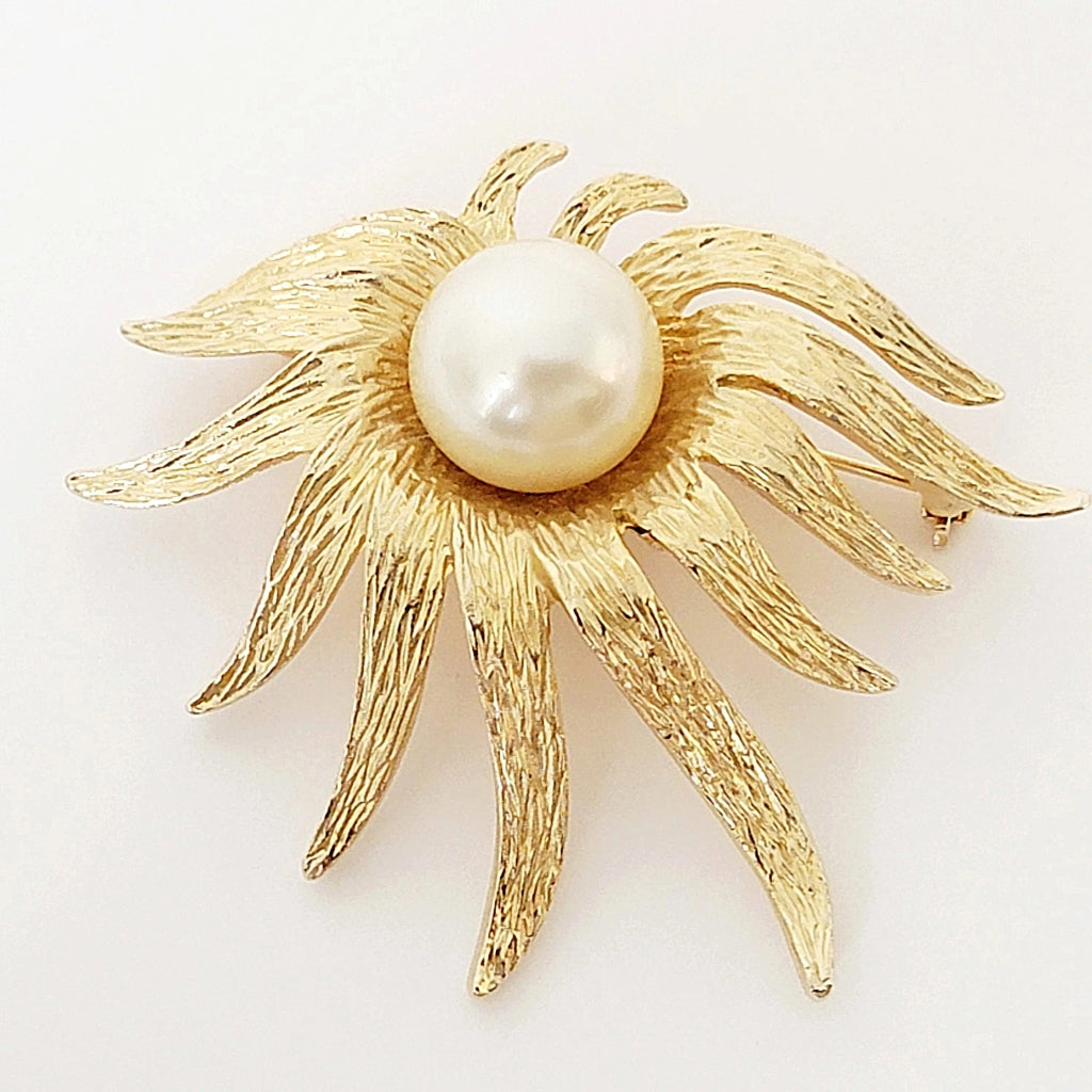 Vintage gold tone modernist style flower pin with large faux pearl.