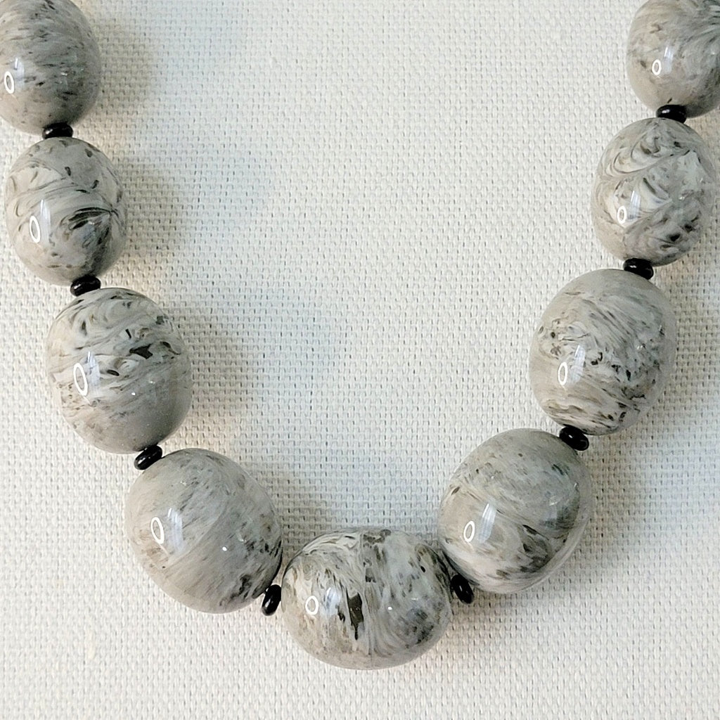 Large gray swirl oval plastic beads.