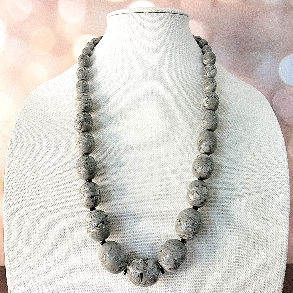 Long gray graduated beaded necklace.