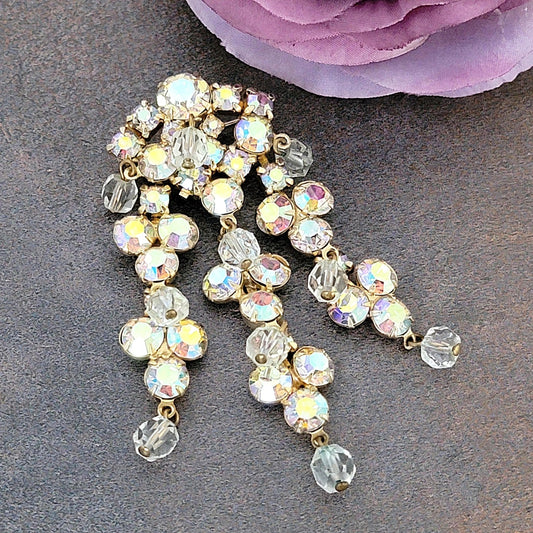 Long dangling rhinestone brooch.