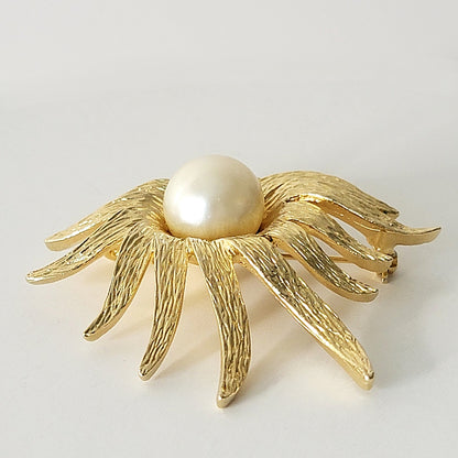 Long gold tone petals on a vintage flower brooch.