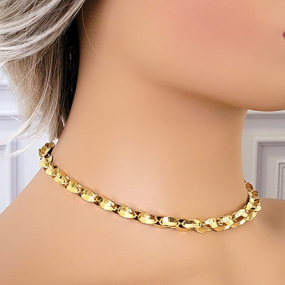 Gold tone choker on a mannequin.