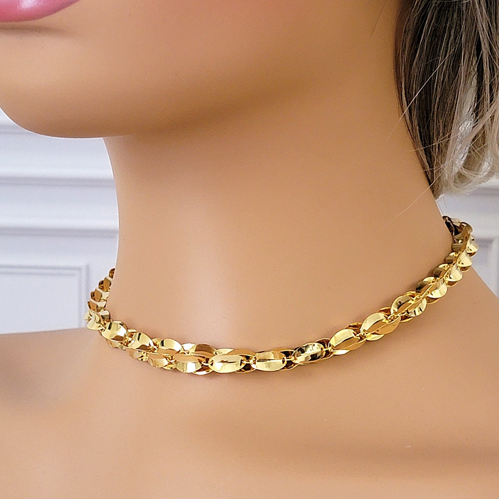 Gold tone link choker necklace on a mannequin.