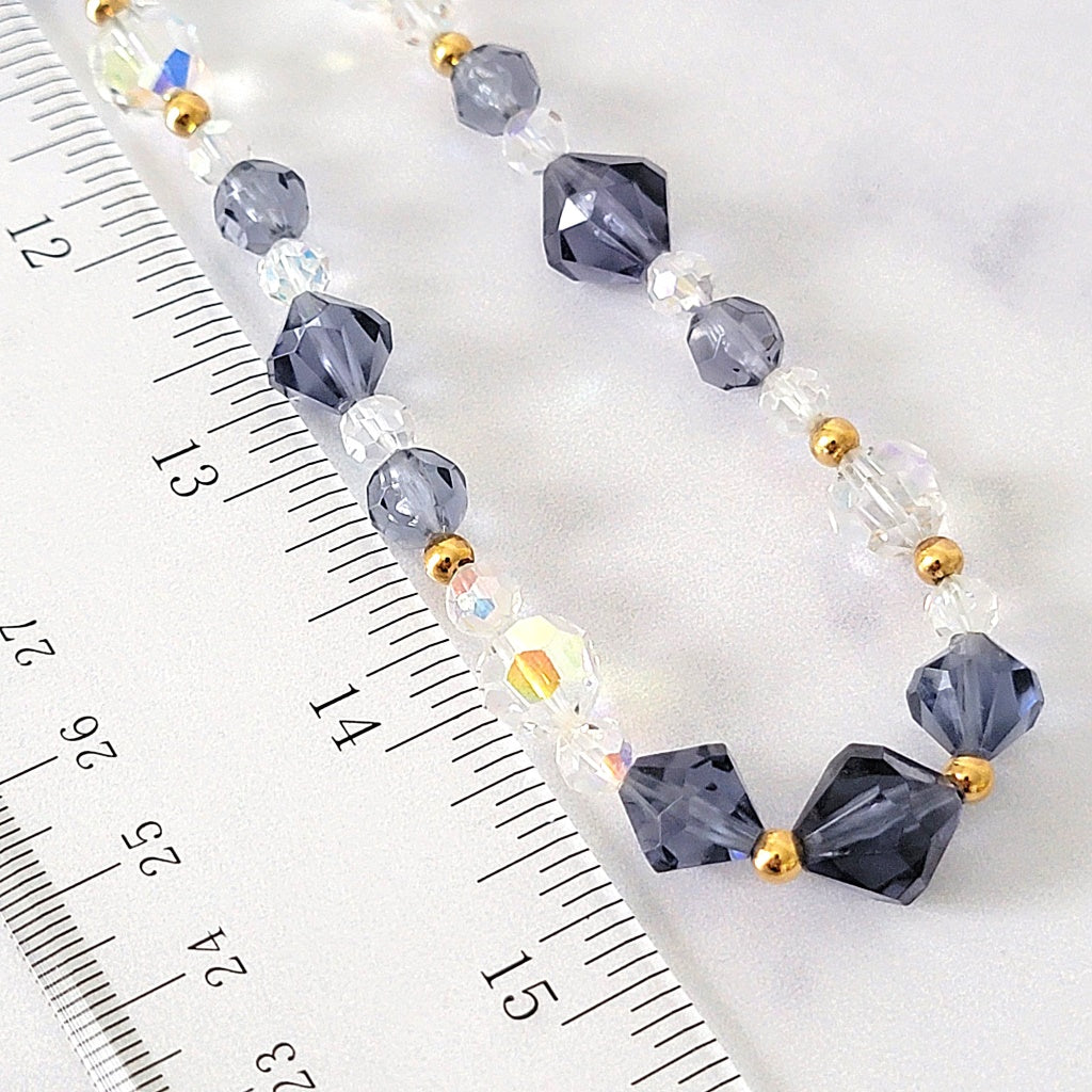 Beaded necklace next to a ruler.