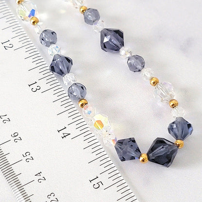 Beaded necklace next to a ruler.