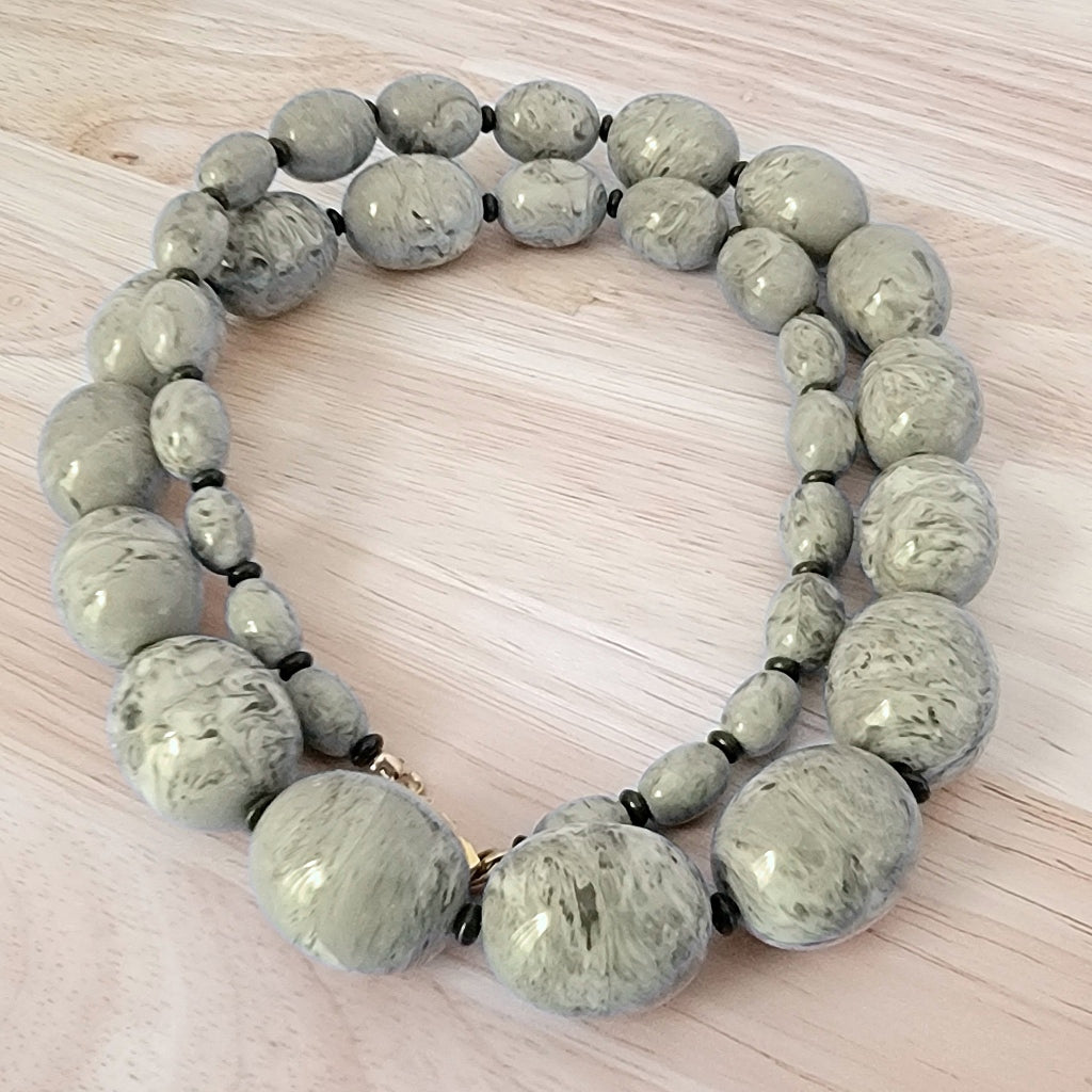 Large gray plastic graduated bead necklace.