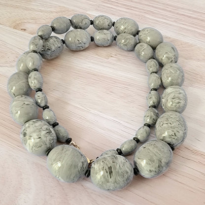 Large gray plastic graduated bead necklace.