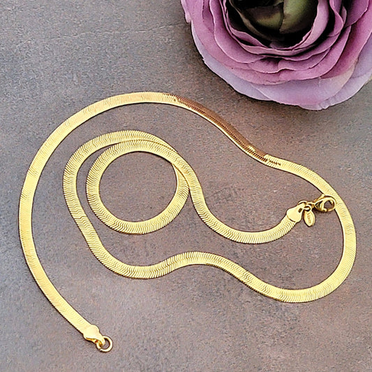 Gold tone flat snake chain.