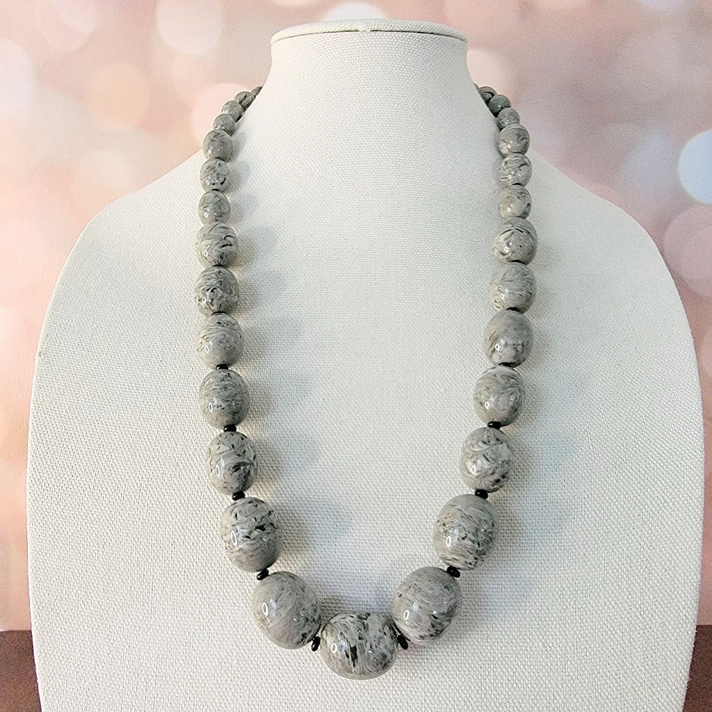 Long gray acrylic necklace.