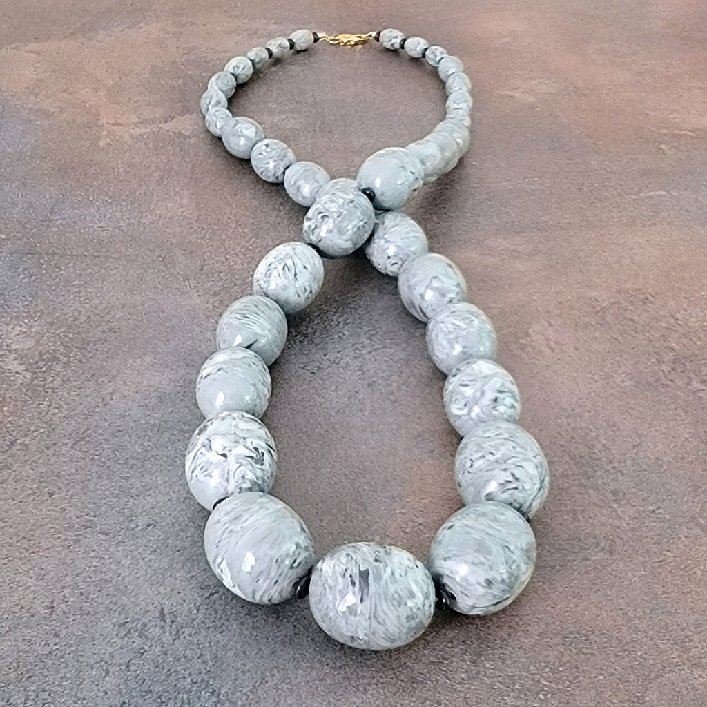 Big chunky gray plastic beaded necklace.