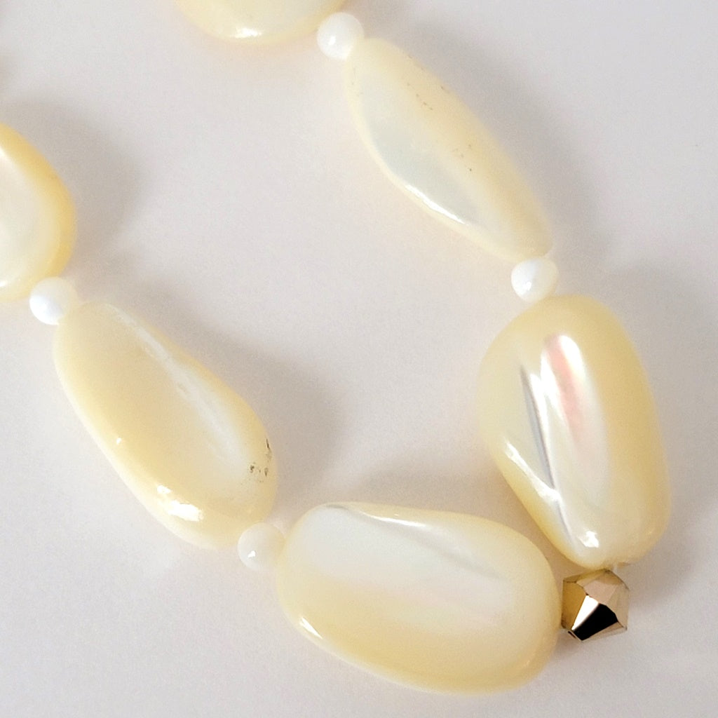 Mother of pearl shell beads with gold crystal.