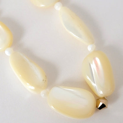 Mother of pearl shell beads with gold crystal.