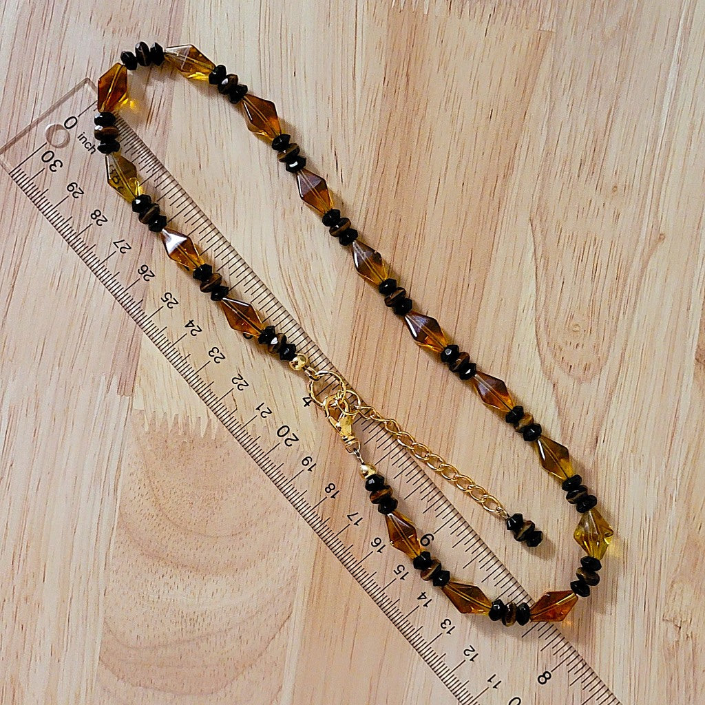 Amber glass necklace with ruler.