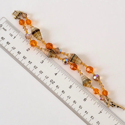 Two strand glass beaded bracelet next to a ruler.