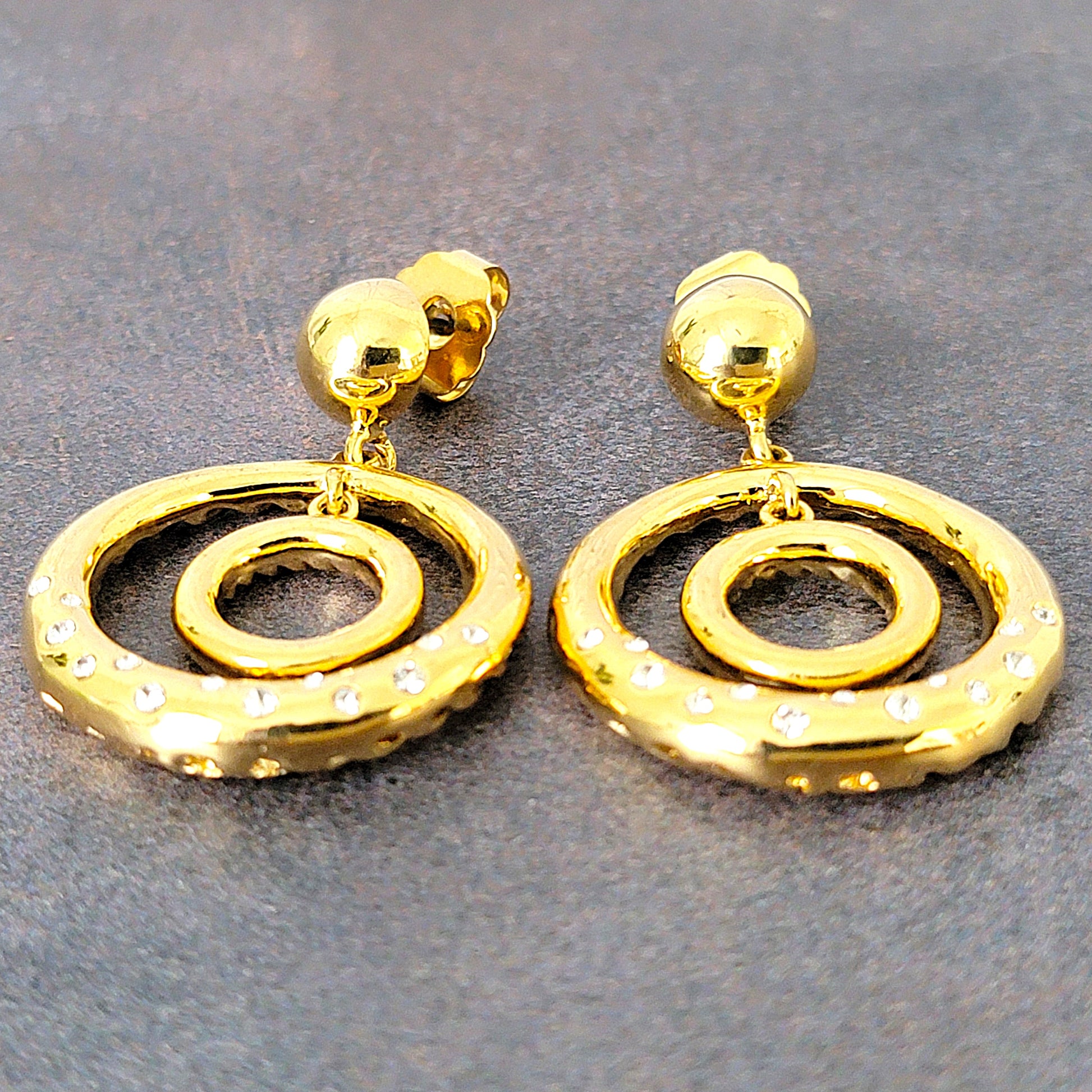 Gold tone hoop earrings with rhinestones.