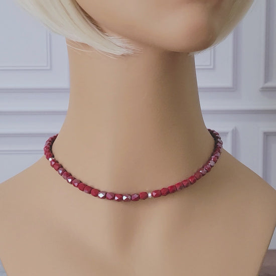 Cherry red choker necklace on a mannequin.