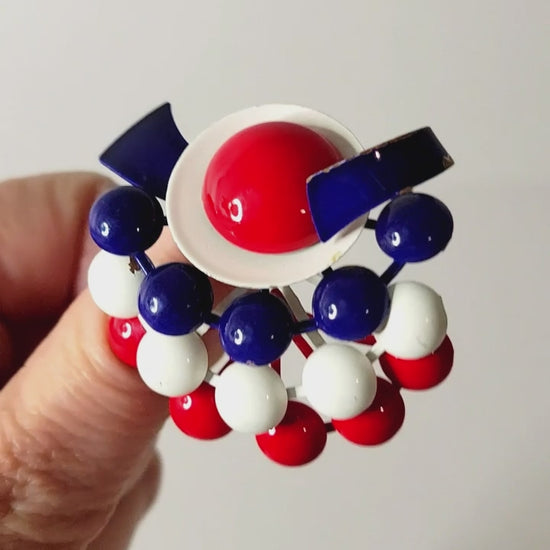 Vintage red, white and blue mod style brooch in hand.