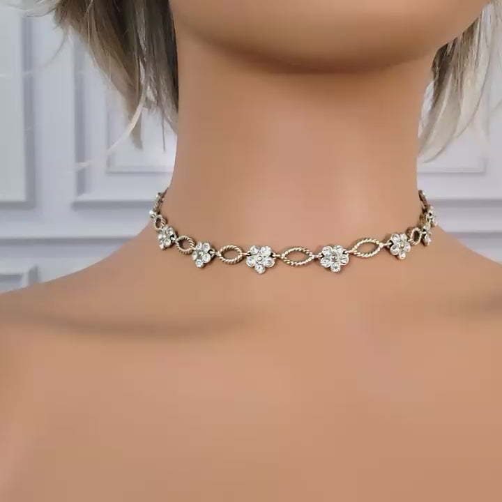 Clear rhinestone flower necklace on a mannequin.