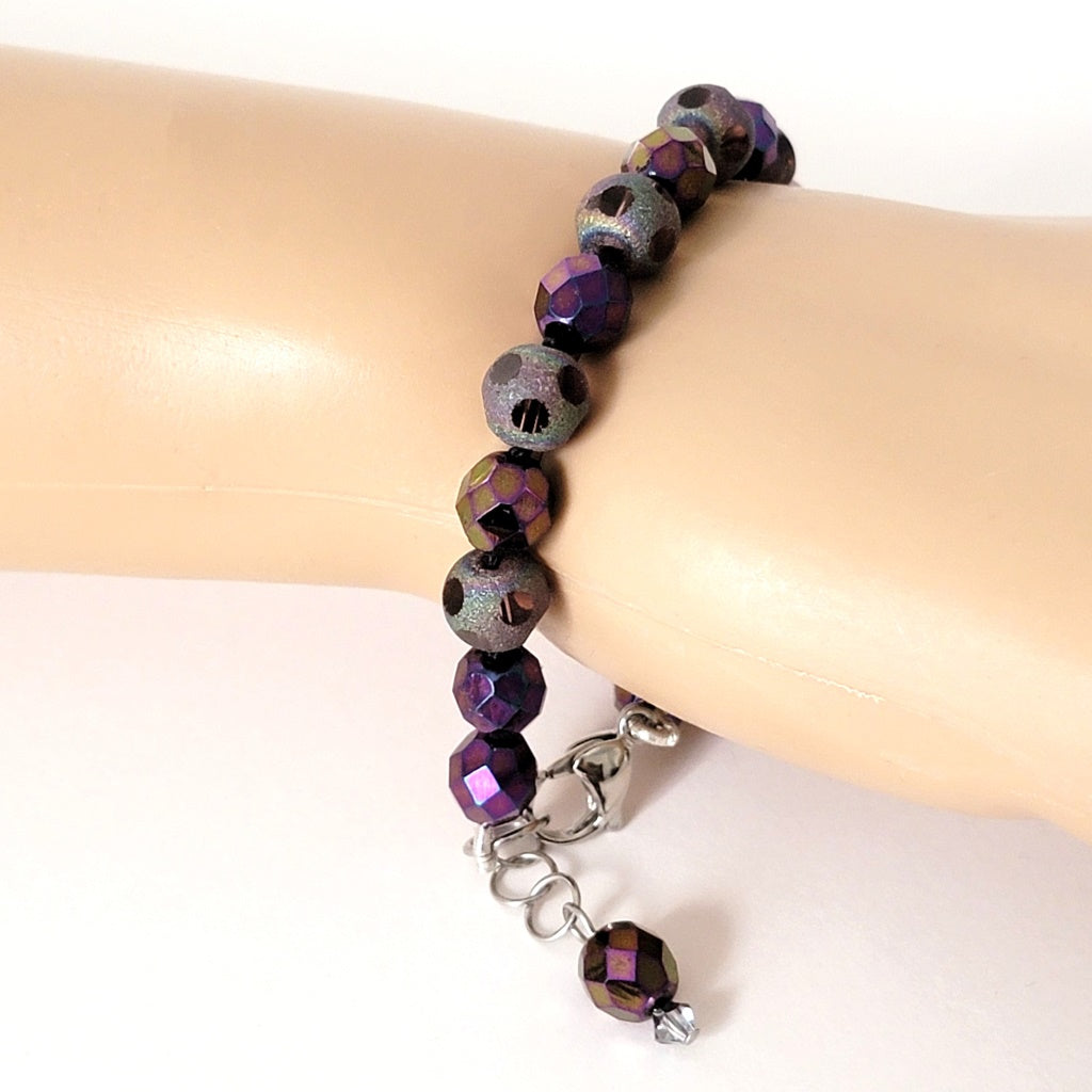 Purple bead bracelet on wrist.