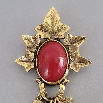 Red acrylic cabochon in leaf setting.