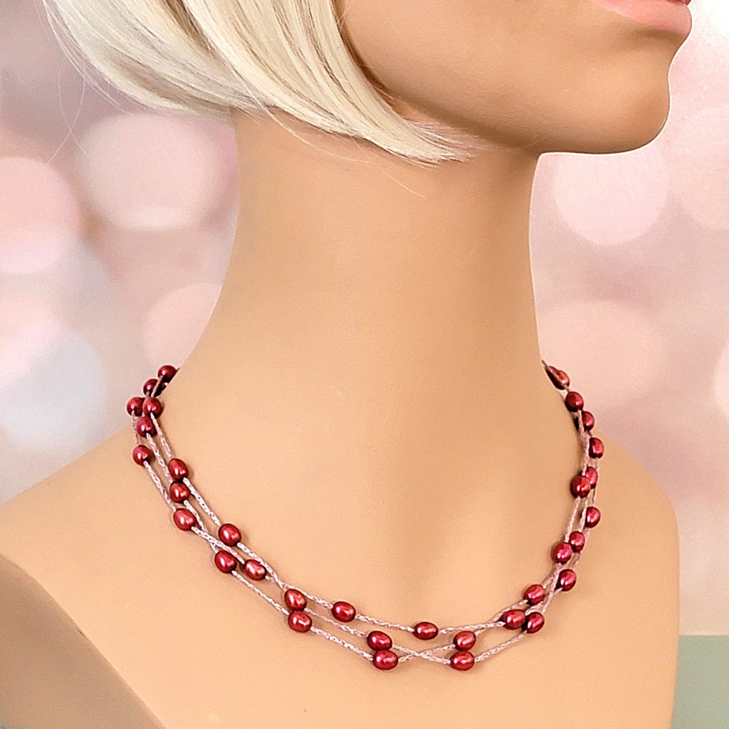 Red pearl necklace on mannequin.