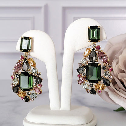 Big multicolor rhinestone earrings on  display.