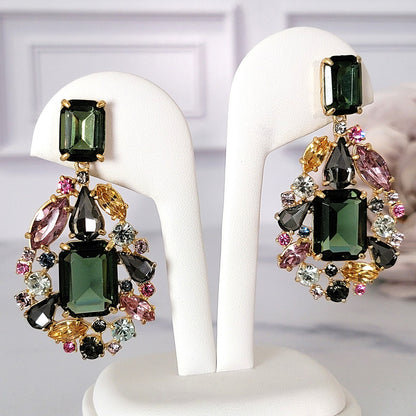 J. Crew large green rhinestone dangling earrings on display.