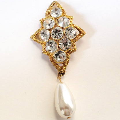 Rhinestone and faux pearl brooch.